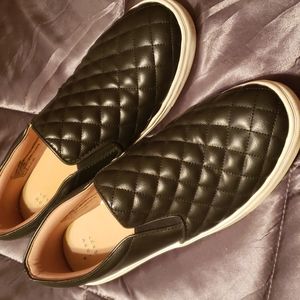 Black quilted leather slip on shoes.